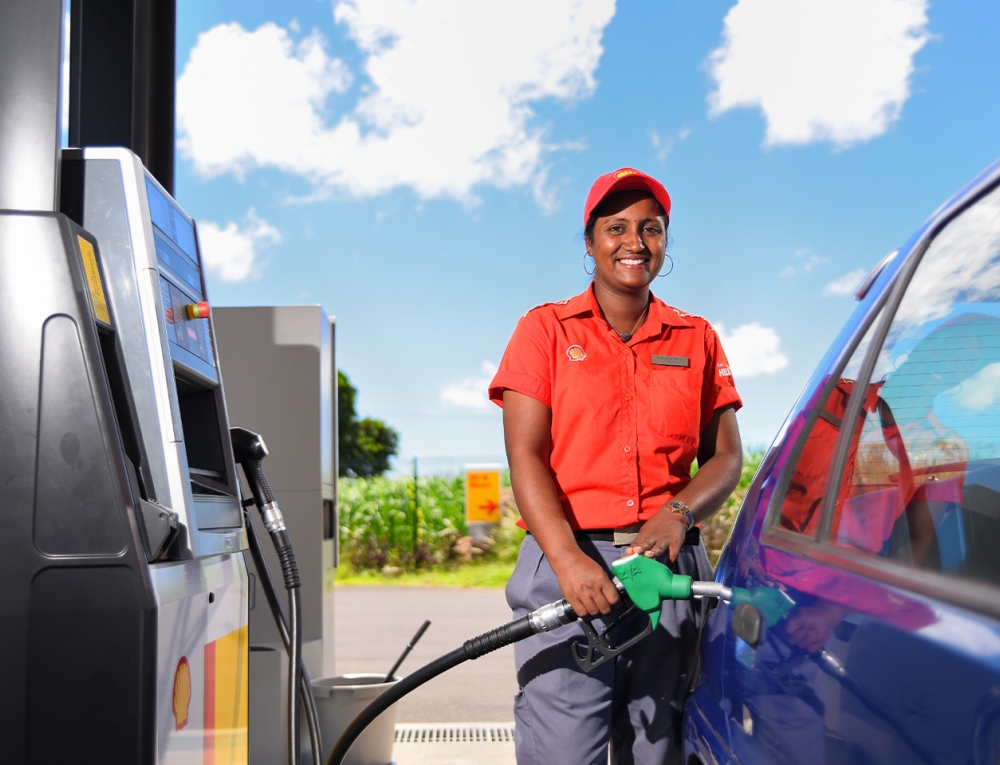 lady refuiling a vehicle